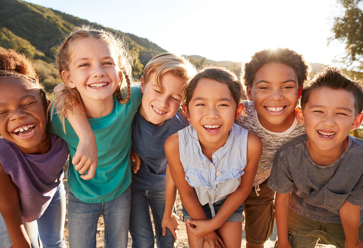Kids smiling arm in arm